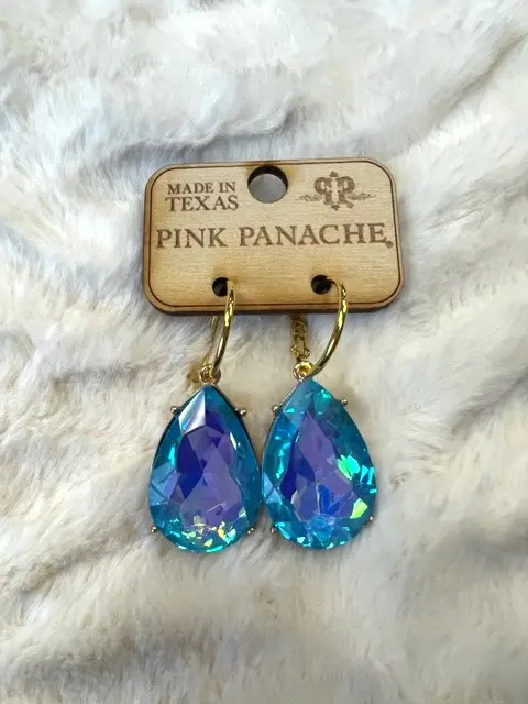 A pair of blue earrings hanging on a white background