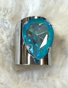 A silver ring with a blue stone on it.