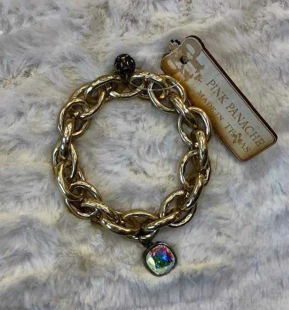 A gold chain bracelet with a charm on it.