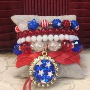A stack of bracelets with red, white and blue beads.