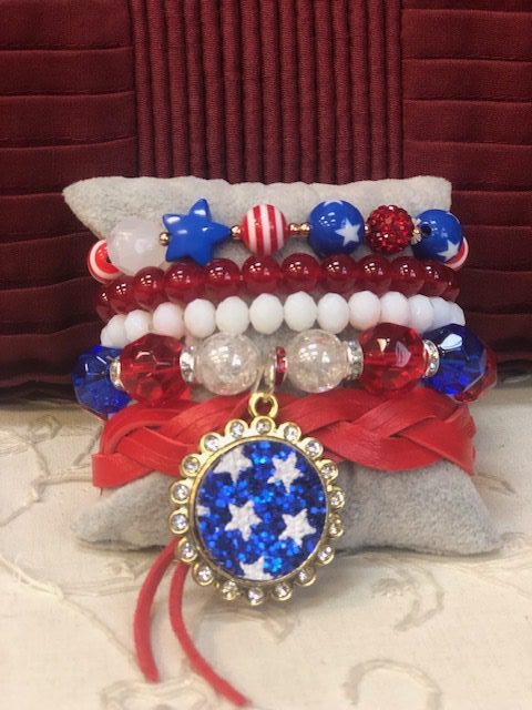 A stack of bracelets with red, white and blue beads.