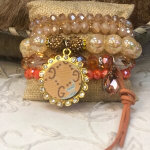 A bracelet with a clock on it and some beads