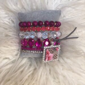 A bracelet with pink and silver beads on it