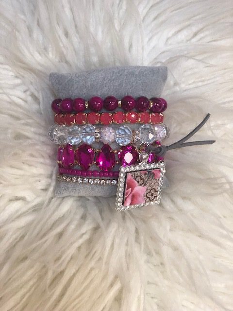 A bracelet with pink and silver beads on it