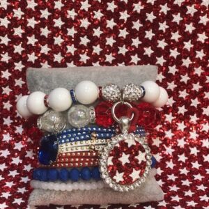 A red white and blue bracelet with a silver star charm.