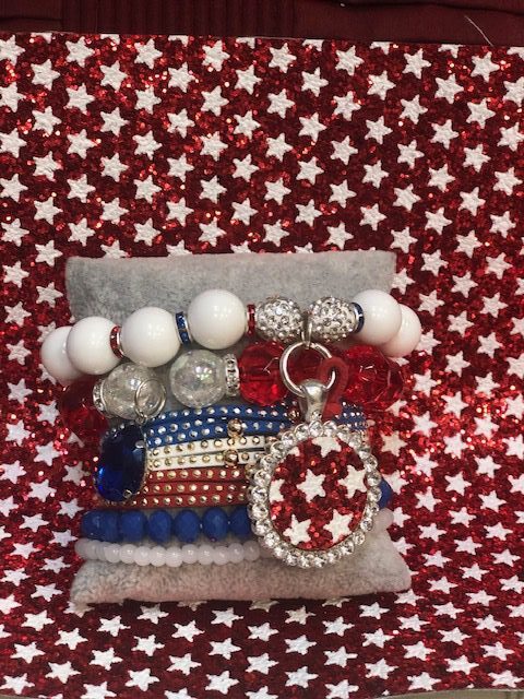 A red white and blue bracelet with a silver star charm.