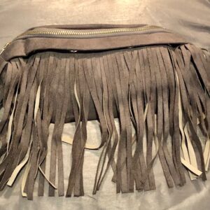 A brown purse with long fringes on top of the bag.