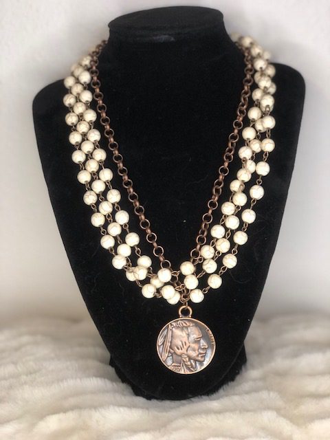 A WHITE TURQUOISE COPPER necklace with a pendant and pearls.