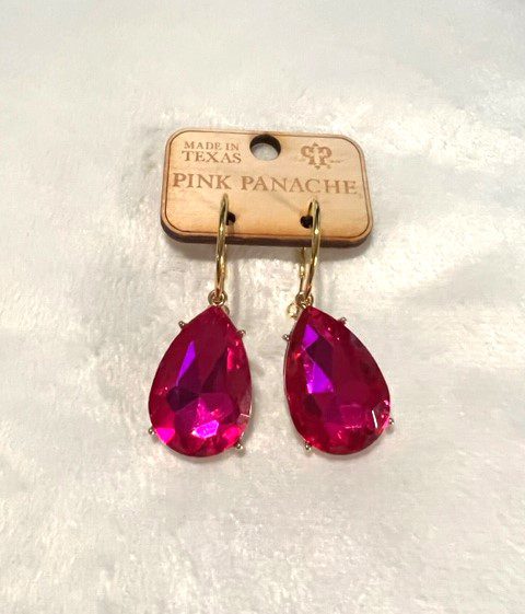 A pair of gold/fuchsia teardrop hoop earrings on a white background.