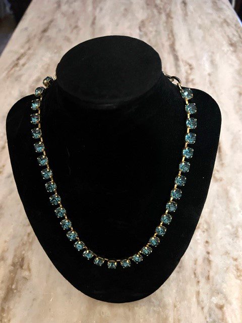 An Oakland necklace with blue crystals on a mannequin.