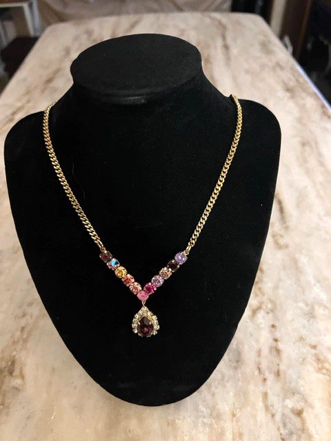 A IVO NECKLACE IN BERRIES with multi colored stones on a mannequin.