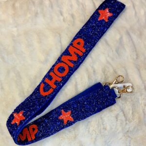 A blue and orange star lanyard with the word " chomp ".