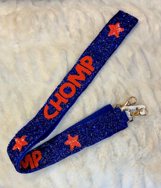 A blue and orange star lanyard with the word " chomp ".