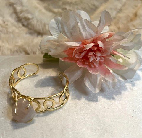 A gold plated cuff with a ROSE QUARTZ STONE BRACELET.