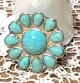 A turquoise colored ring sitting on top of a table.