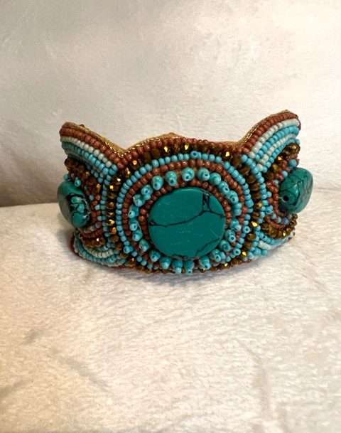 Turquoise and brown acrylic bead cuff bracelet.