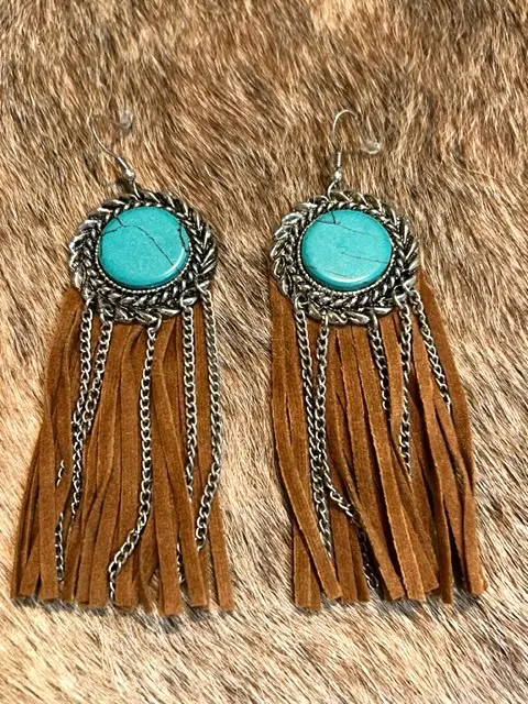 A pair of UKIYO earrings with turquoise stones.