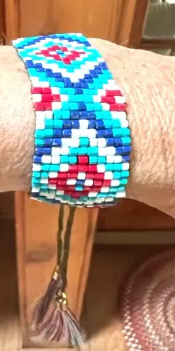 A close up of the wrist of someone wearing a bracelet