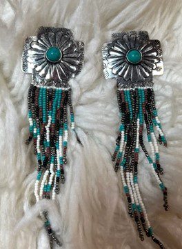 A pair of earrings with beads and metal