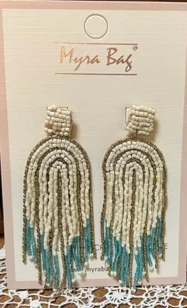 A pair of earrings on display in front of a white card.