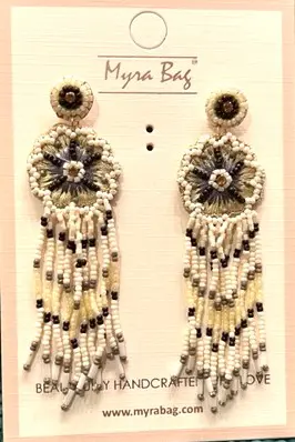 A pair of earrings with beads and flowers.