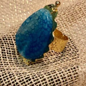 A blue ring is sitting on top of a white cloth.