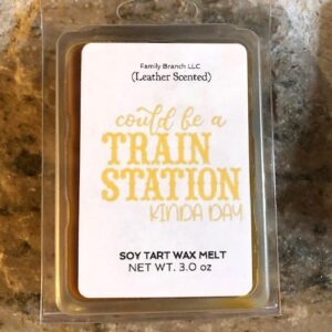 A candle with the words 'Train Station Kind of Day Wax Melts' on it.