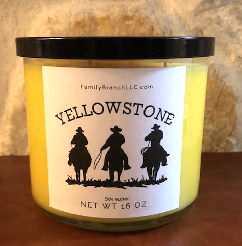 A jar of YellowStone 3 Wick Candle on a table.