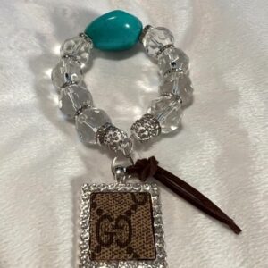 A TURQUOISE UPCYCLED BRACELET STACK with a turquoise stone on it.