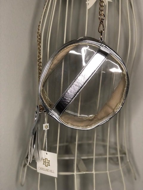 A MADISON CLEAR CROSSBODY with a chain hanging from it.