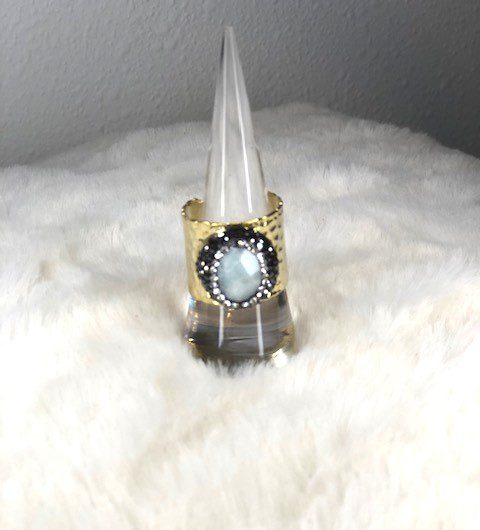 A Jasper cuff ring with a blue stone sitting on top of a cone.