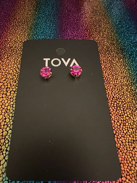A pair of OAKLAND STUDS IN FUSCHIA earrings with the word tova on them.