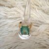 A GOLD MINT AB RECTANGLE RHINESTONE RING with an emerald cut stone.
