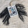 A black and white Yee Haw Freshie with fringes on it.