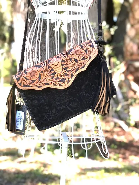 A TOOLED BLACK FRINGE SMALL PURSE with tassels and a tassel.