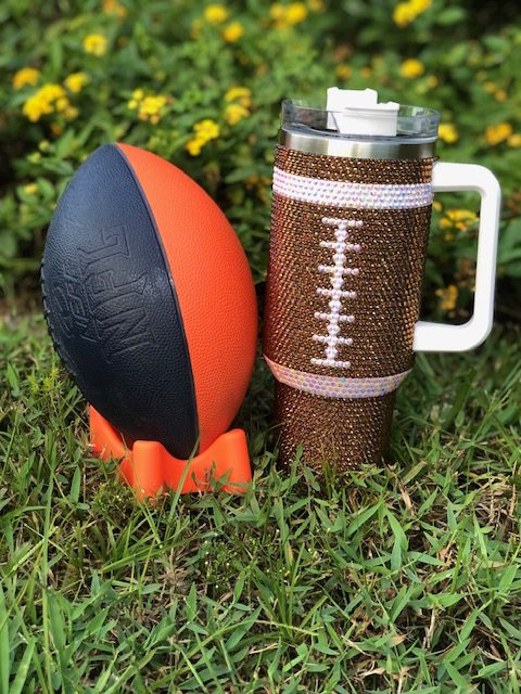 A coffee mug with a CRYSTAL FOOTBALL 40 OZ TUMBLER on it.