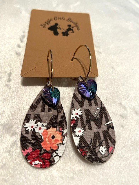 A pair of MK JAZZIE EARRINGS WITH STONE with flowers on them.