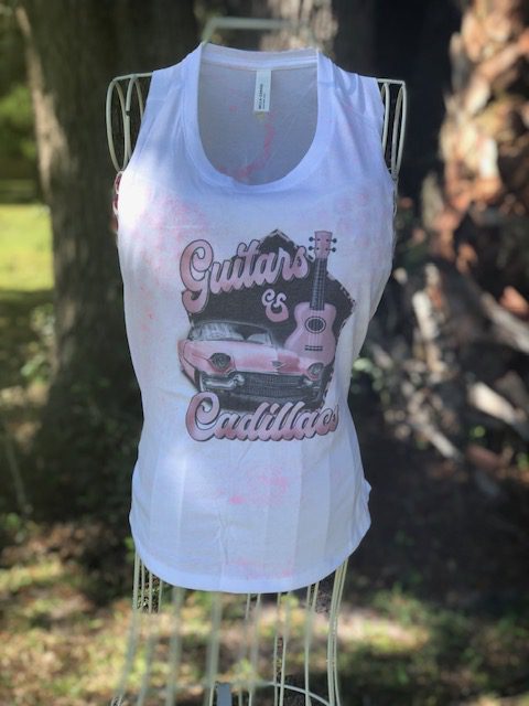 A white tank top with a pink Guitars and Cadillacs Crop on it.