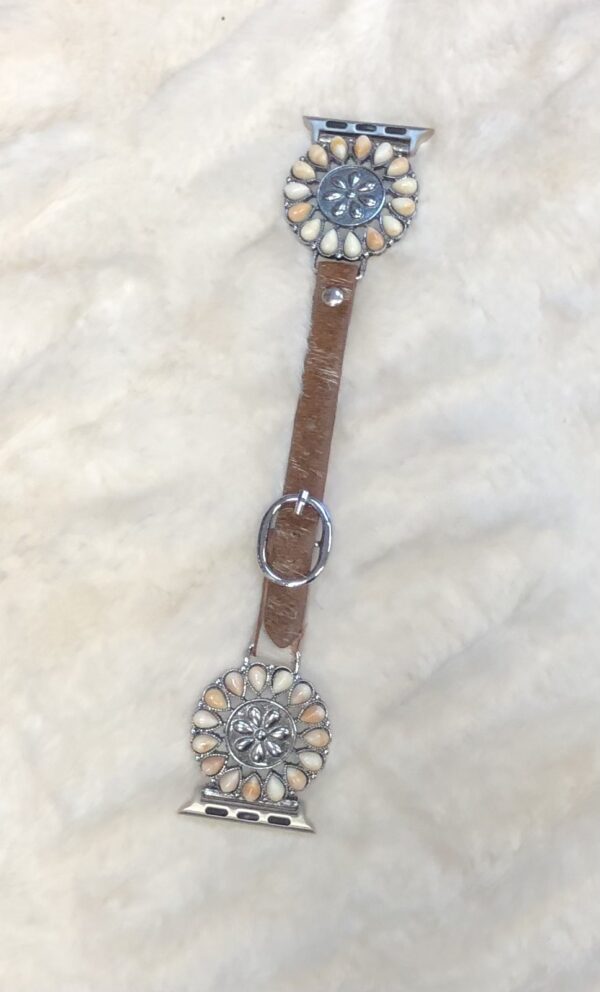 A COQUESE LEATHER WATCH BAND with a flower on it.