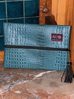 A SHADE OF JADE MAKEUP BAG with a black tassel.