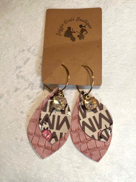A pair of MK Layered Cream Jazzie earrings with a tag on them.