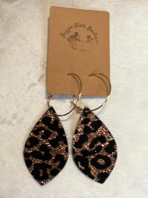 A pair of SHINY LEOPARD JAZZIE earrings on a white background.
