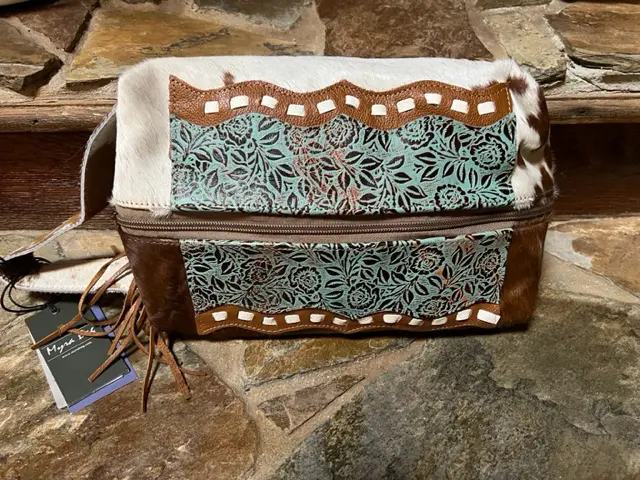 A cowboy style SOUTHWEST MAKEUP KIT with tassels on it.