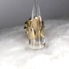 A TWIGGY RING IN METALLIC GOLD with a clear cone on top.
